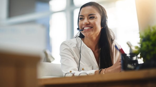 RealNex client success manager wearing a headset at her desk.